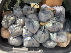 Car full of backpack bags ready for delivery to students